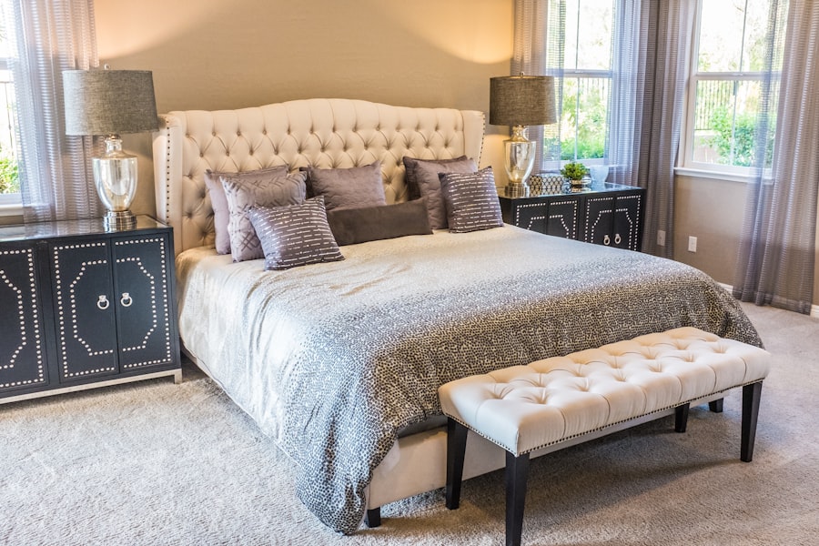 Double bed with exactly four cushions — two sleeping pillows in white cases against the headboard, two decorative cushions in front in a tonal complement — the correct cushion count for a double bed