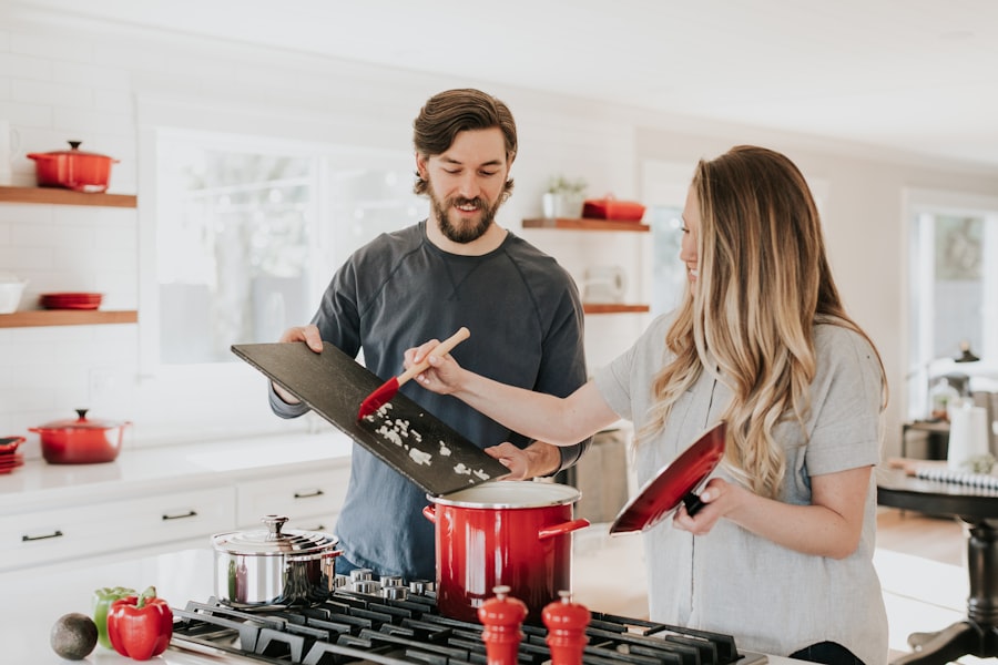 Kitchen with wall-mounted magnetic knife strip, hanging rail with S-hooks for utensils, and a pegboard panel for frequently used cooking tools — vertical wall storage that clears the counter and drawers