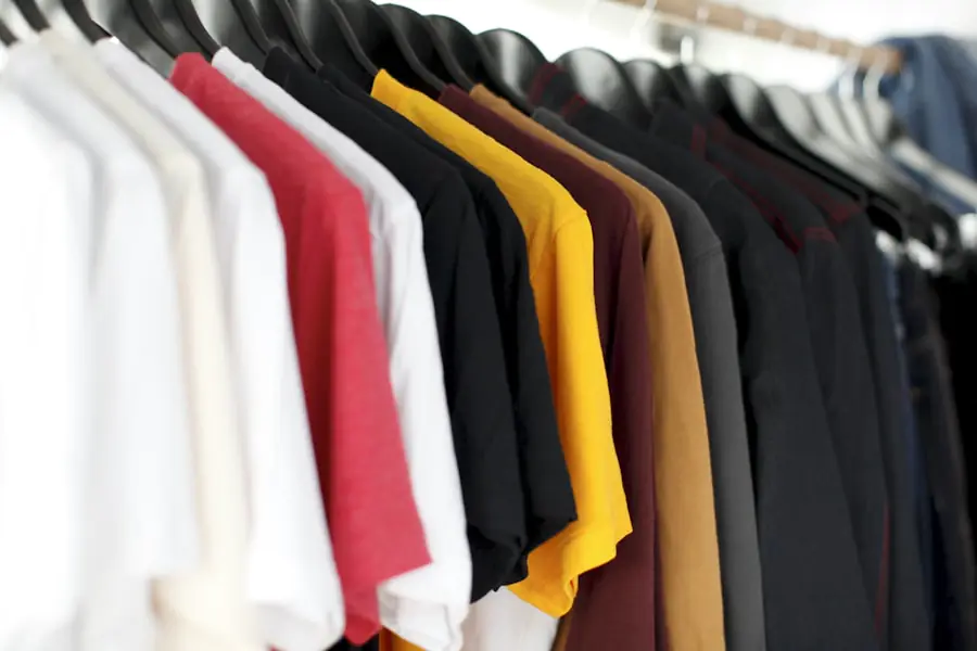 Neatly organized clothing drawer with a fixed number of folded items — category-specific one-in one-out rule applied to a single clothing category with a defined capacity limit