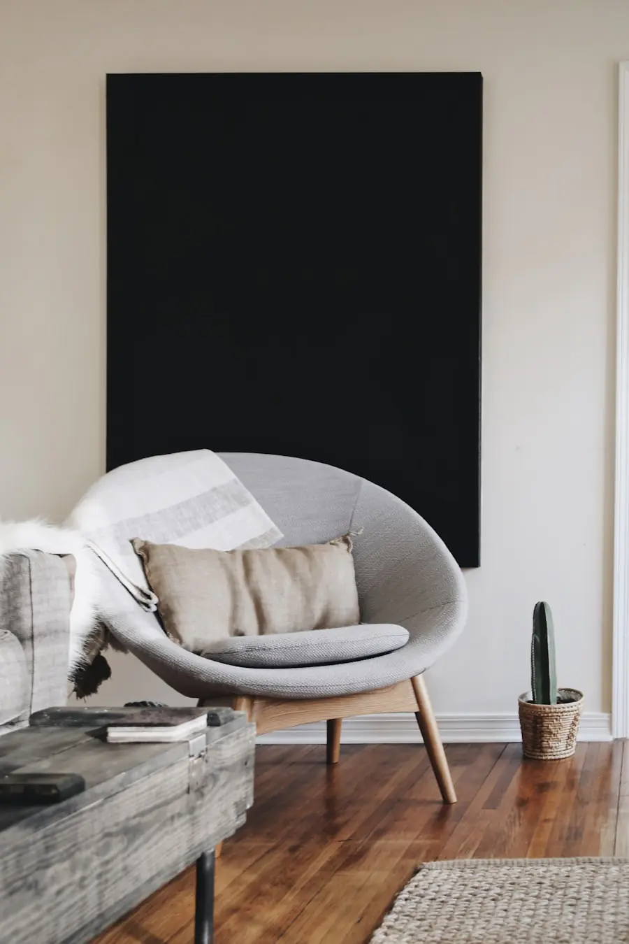 Single large format artwork on a living room wall occupying 60 percent of the wall width — demonstrating how scale and confidence in art selection reads as designed rather than accumulated